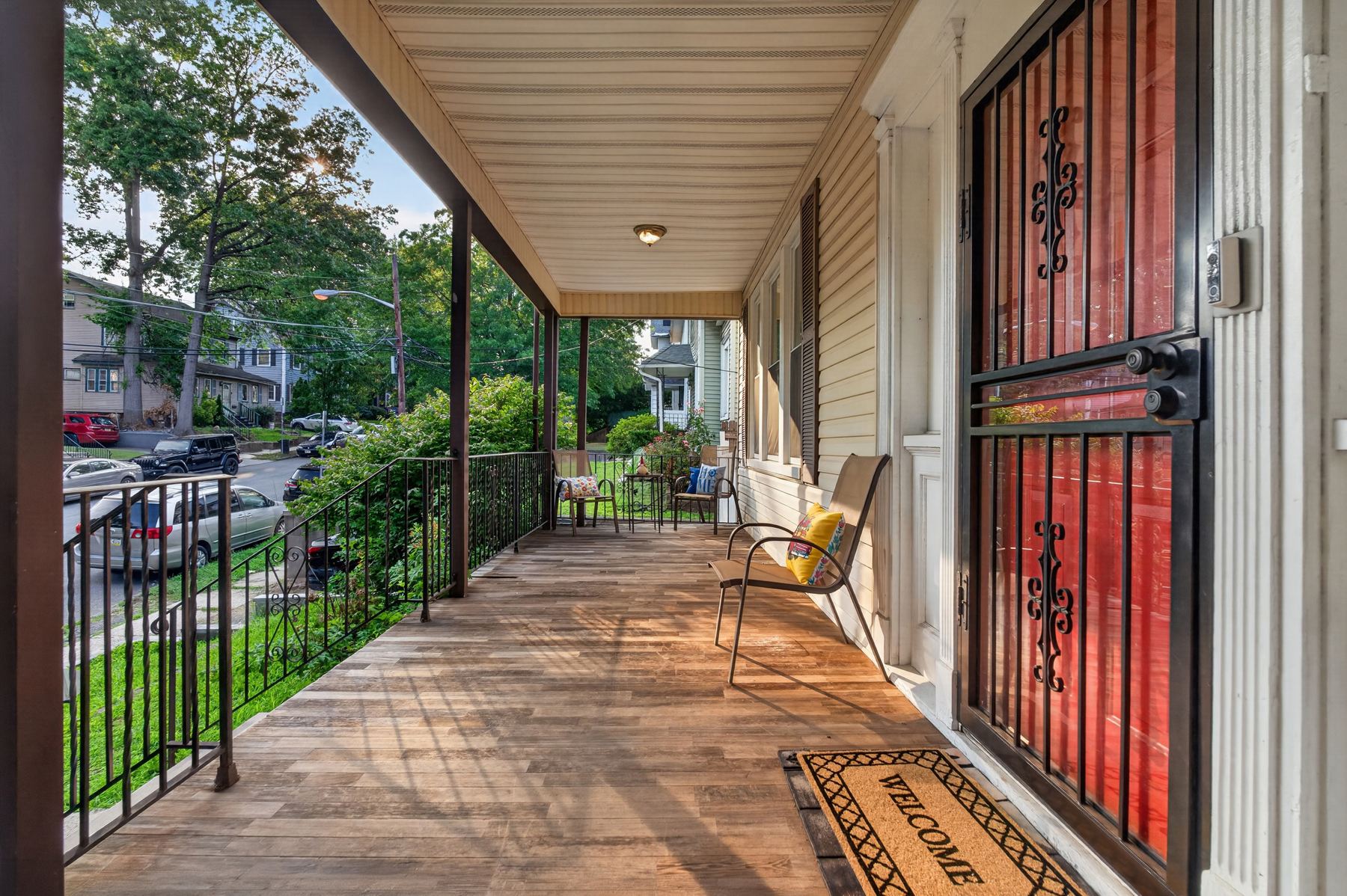 Front porch, red door, and welcome mat